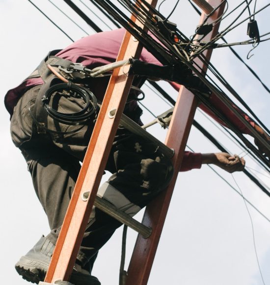 man on top of electrical wires